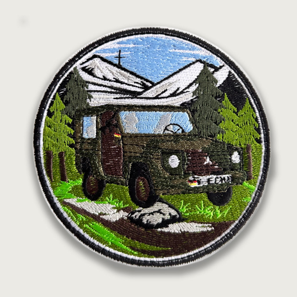 Embroidered military patch – Green off-road vehicle with German flag in alpine forest and mountain background