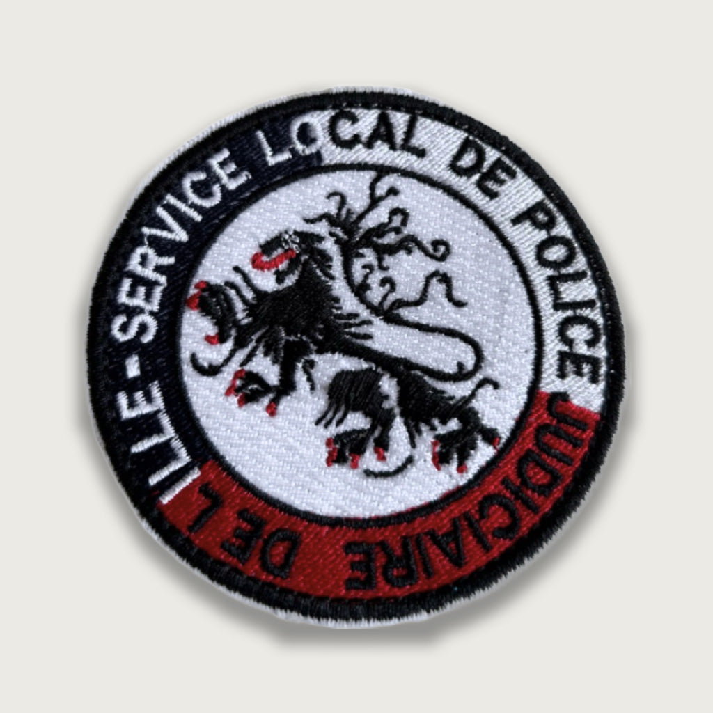 Embroidered French Police Judiciaire patch from Lille featuring a three-headed lion design in black, red, and white.