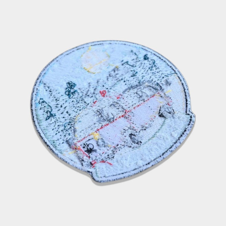 Backside of an embroidered patch with sew-on backing, ideal for stitching onto jackets, bags, or uniforms.