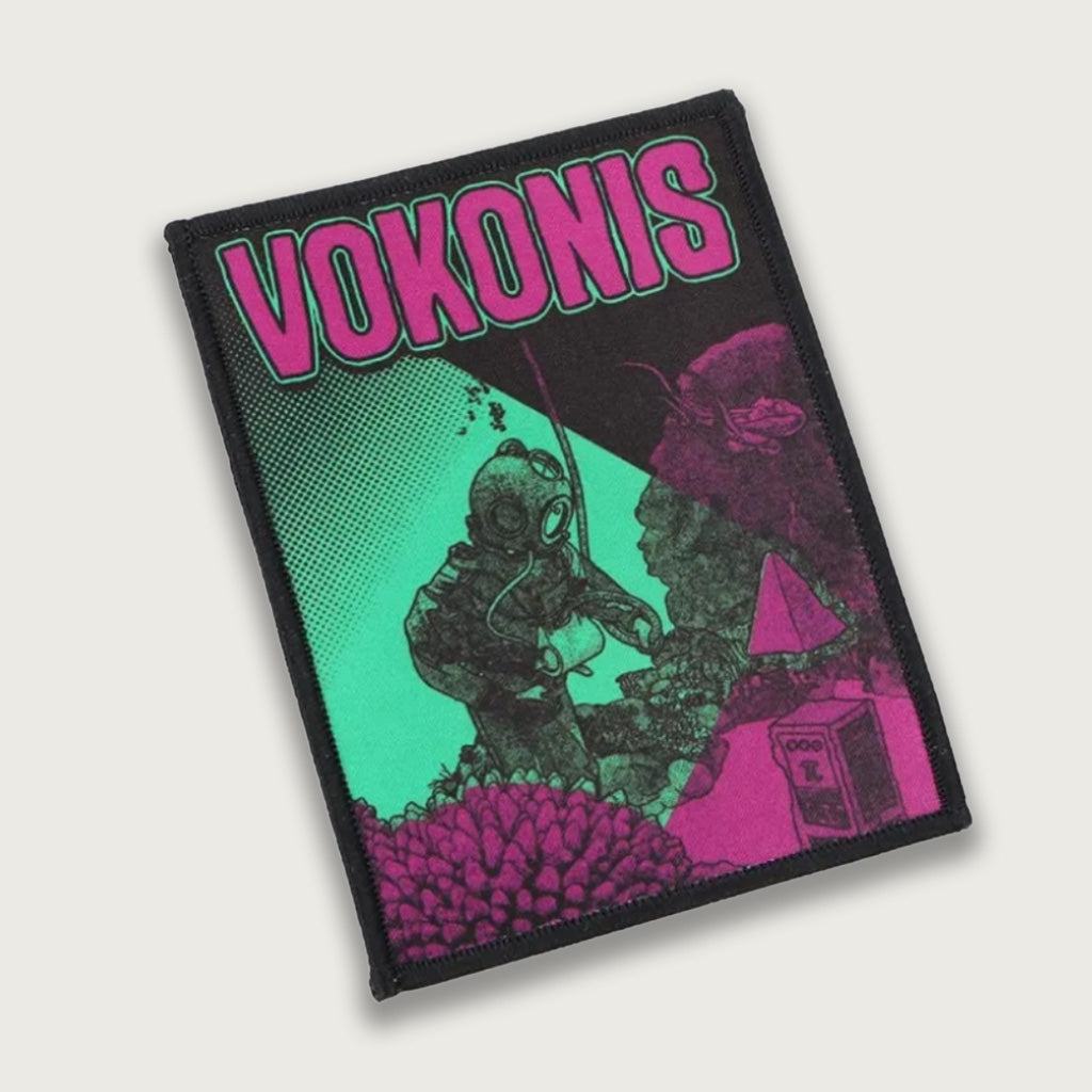 Sublimated patch featuring the Vokonis band logo with a psychedelic diver illustration in neon pink and green tones. Bold rock band design with vibrant sci-fi elements